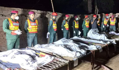 Rescue workers gather near the bodies of the victims